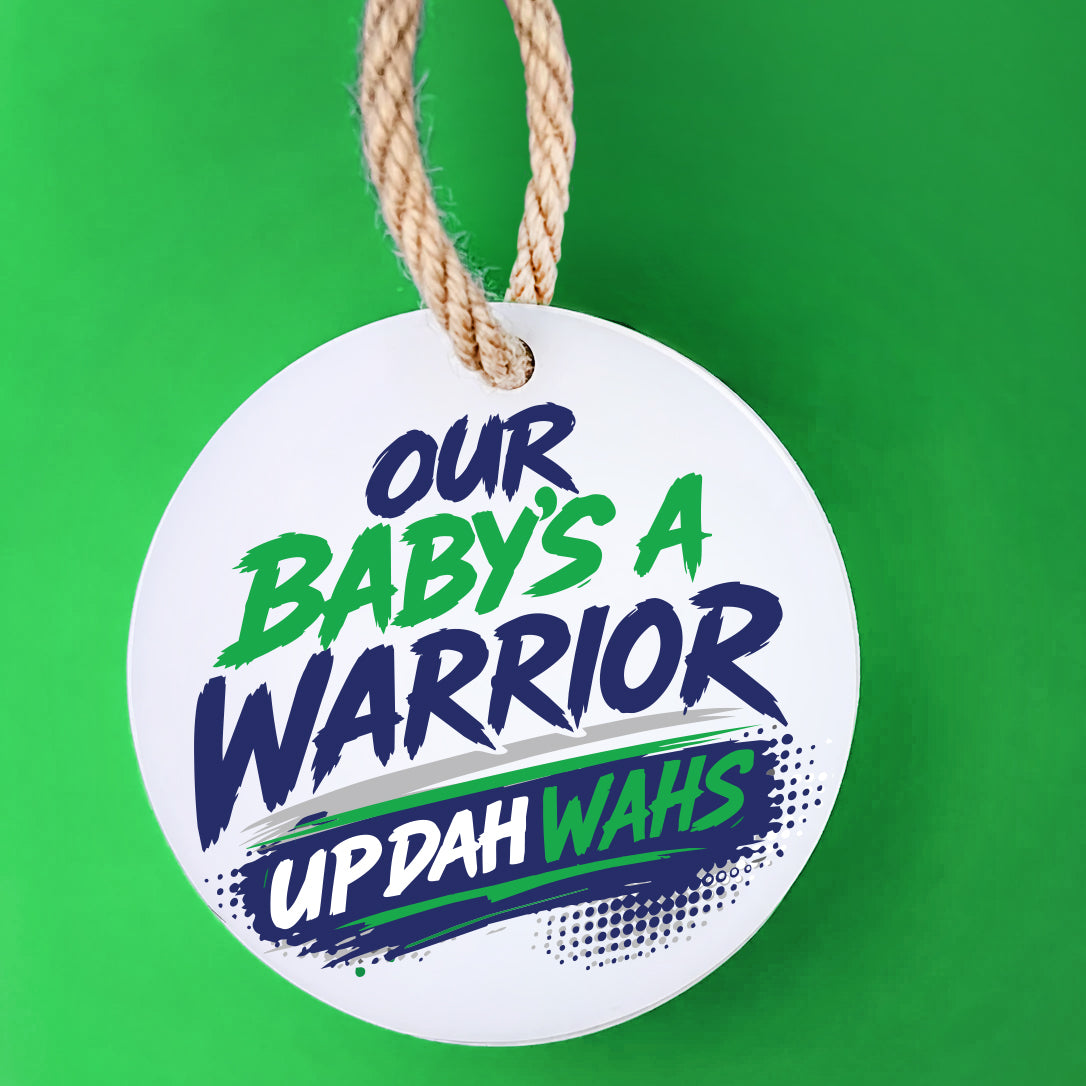 Our Baby's a Warrior UP DAH WAHS keepsake on a green background